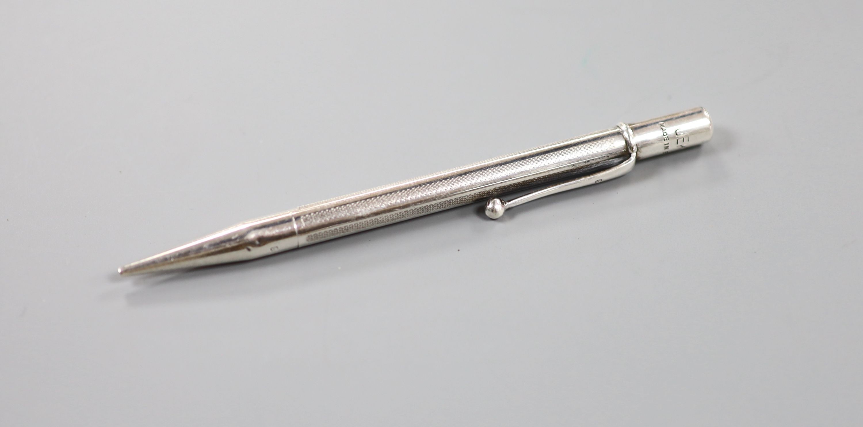A 1940's silver cased propelling pencil, four assorted silver medallions and a silver albert.